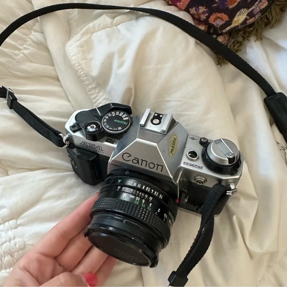 Canon AE-1 35mm Film Camera in Silver and Black with Lens